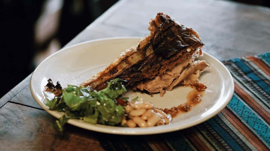 Crossing the Andes: Fagnano and Escondido lakes with lamb - Lamb at the stake in a winter center